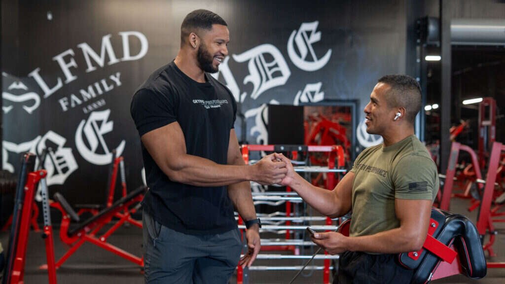 Coaching and progress tracking with a client at Gryffon Performance in Dallas