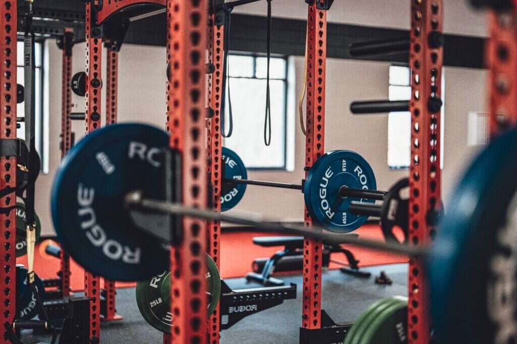 Racked barbells and weight plates in a private training studio