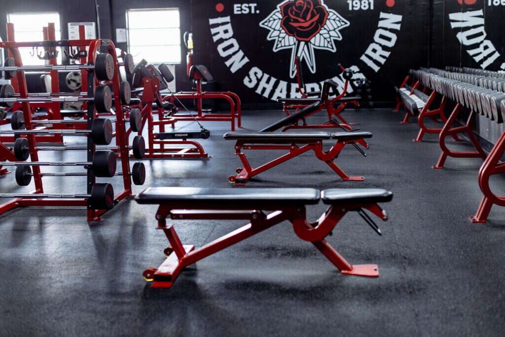 Benches and wall signage beside natural light at the Gryffon Performance training studio in Dallas