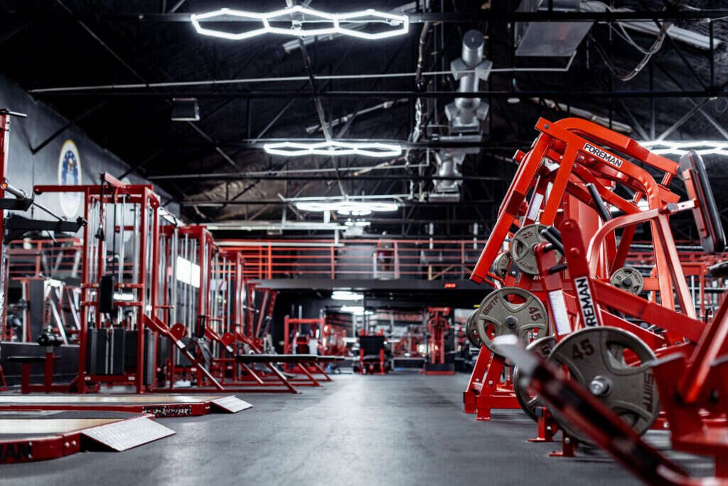 Weight plate storage lining the wall of the Gryffon Performance facility