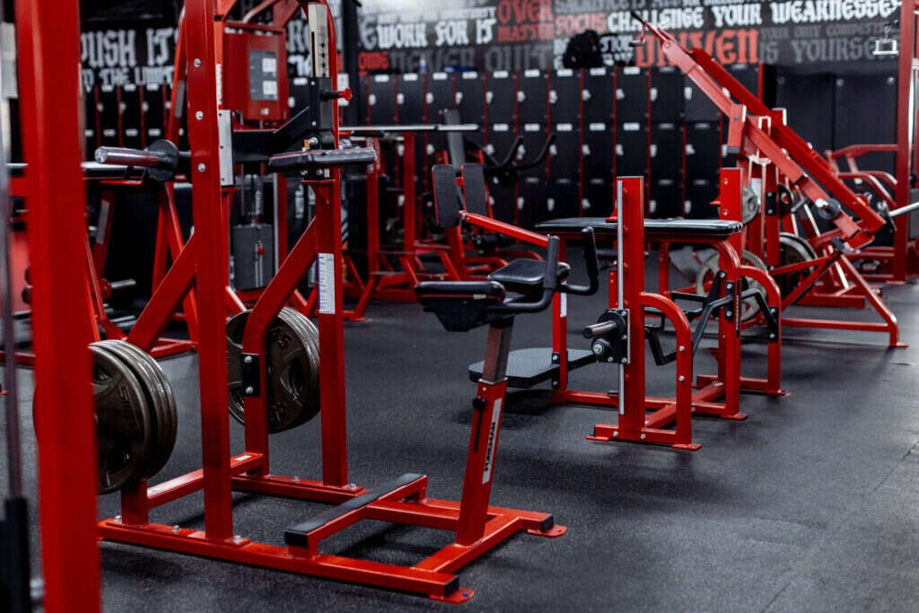 Bench press stations and dumbbell wall inside a private personal training facility in Dallas