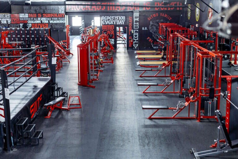 Rows of squat racks lining the main aisle of the 15,000 square foot Gryffon Performance training floor in Dallas
