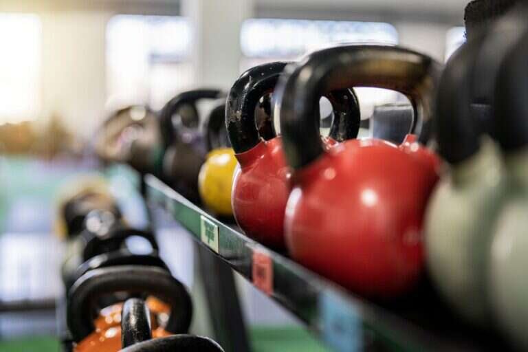 Kettlebells racked in a clean private training studio