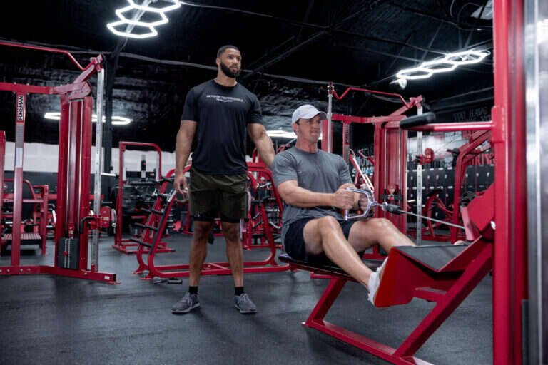 Seated cable row with a personal trainer watching form at Gryffon Performance in Dallas