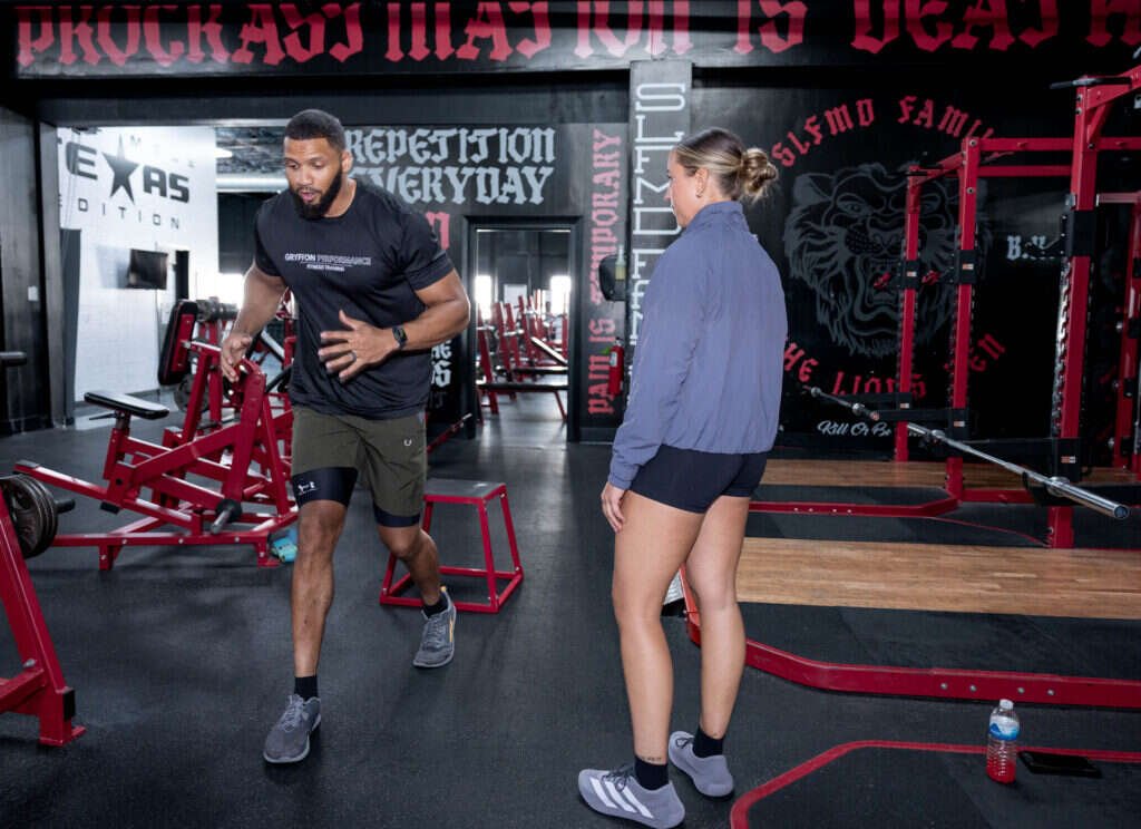 Personal trainer explaining the next exercise at Gryffon Performance in Dallas
