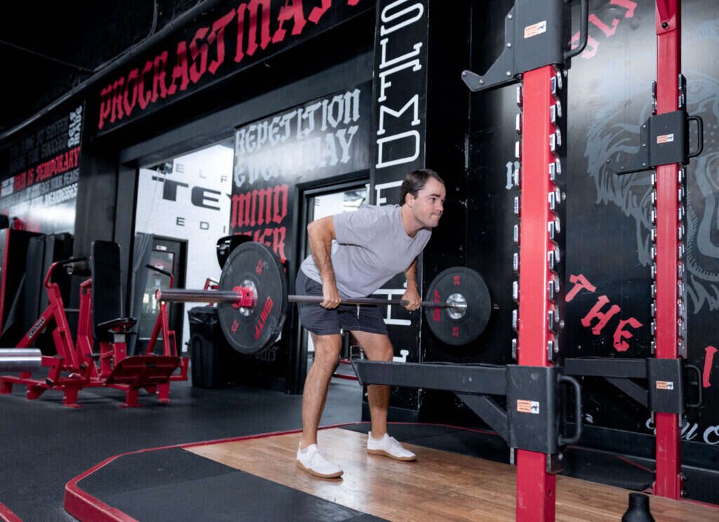 Barbell hip hinge at the private Gryffon Performance training studio in Dallas
