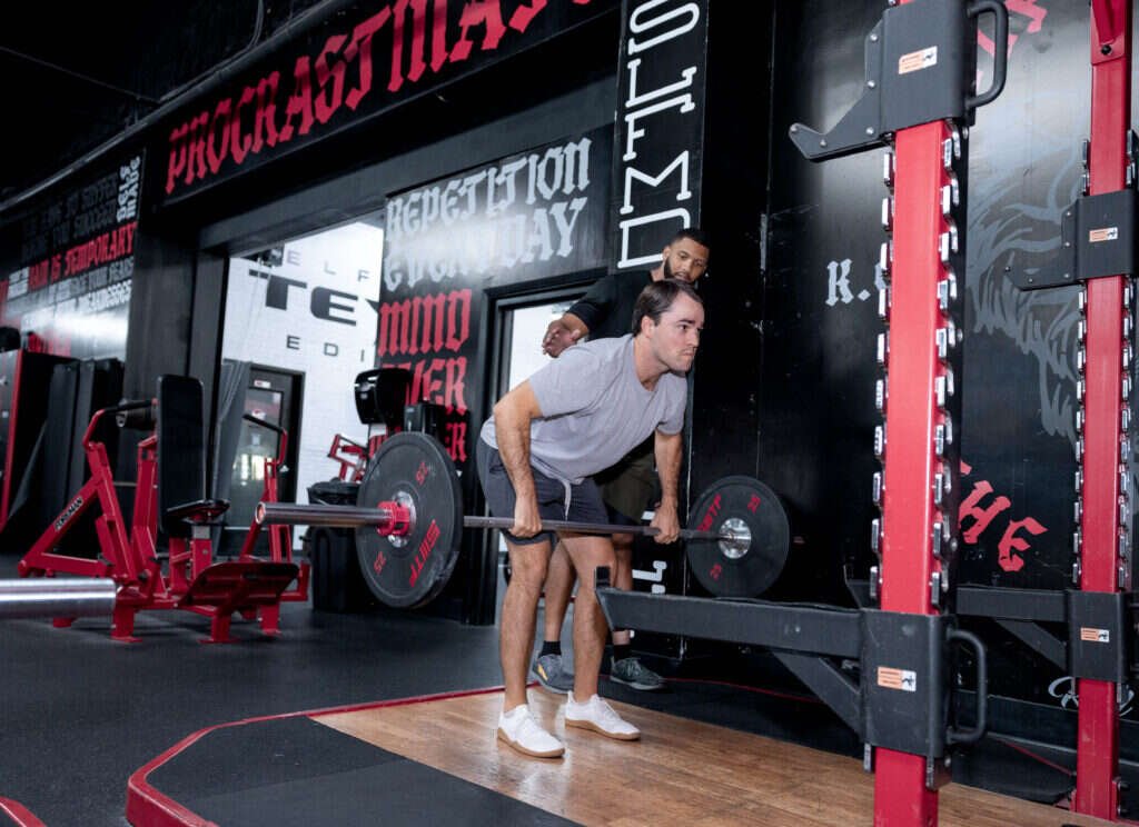 Barbell Romanian deadlift with a personal trainer watching at Gryffon Performance in Dallas