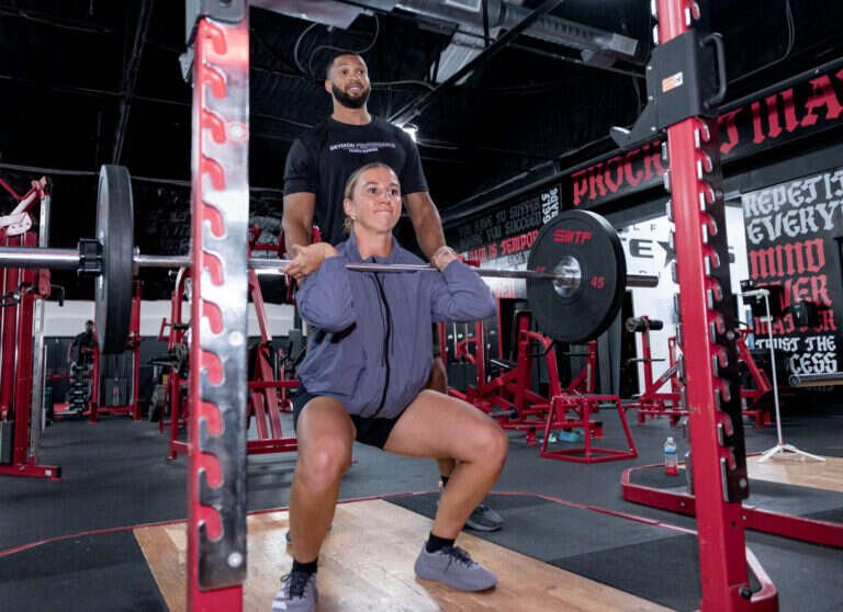 Barbell front squat coached by a personal trainer at Gryffon Performance in Dallas